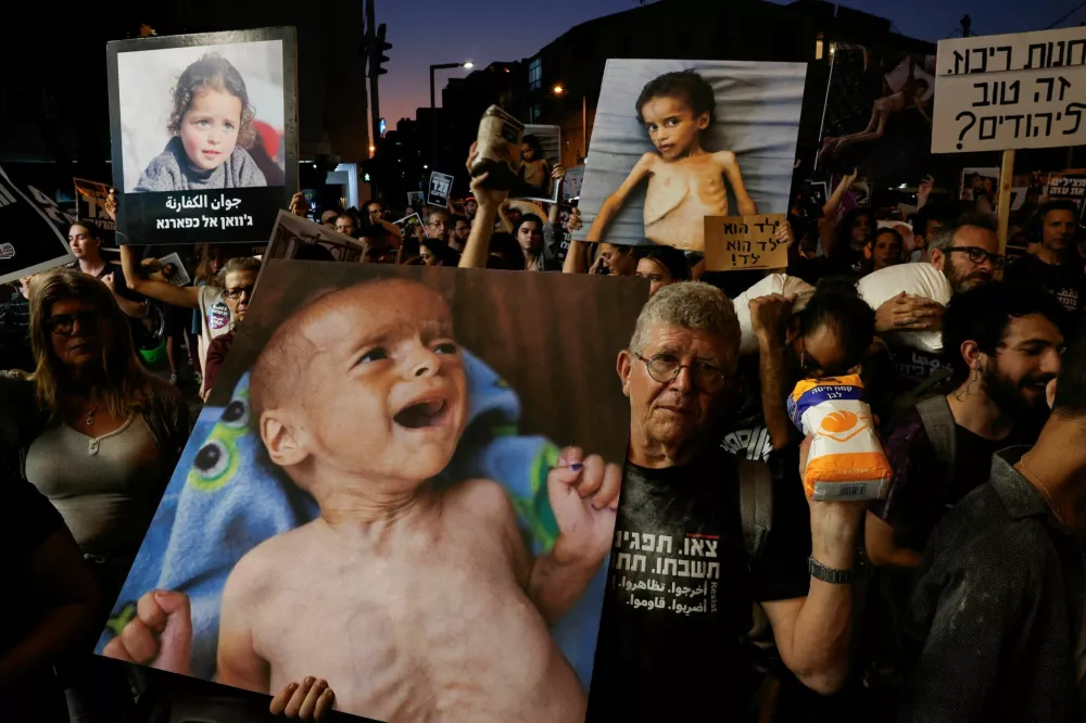 A demonstrator holds a bag of flour, during a protest demanding an end to the war in Gaza and the release of all hostages, in Tel Aviv, Israel, July 22, 2025. REUTERS/Ammar Awad NO RESALES. NO ARCHIVES