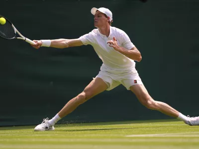 Jannik Sinner of Italy plays a return to Luca Nardi of Italy during their first round men's singles match at the Wimbledon Tennis Championships in London, Tuesday, July 1, 2025.(AP Photo/Kirsty Wigglesworth)