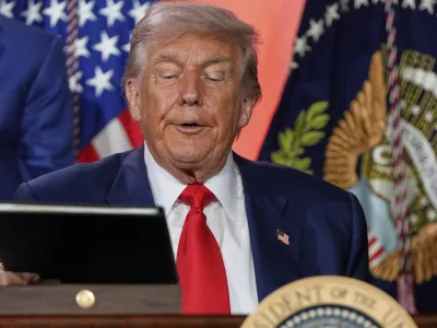 President Donald Trump signs executive orders after speaking during an AI summit at the Andrew W. Mellon Auditorium, Wednesday, July 23, 2025, in Washington. (AP Photo/Julia Demaree Nikhinson)