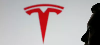 A-3D printed miniature model of Elon Musk's face and Tesla logo are seen in this illustration taken July 23, 2025. REUTERS/Dado Ruvic/Illustration