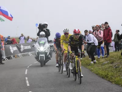 Denmark's Jonas Vingegaard, front, Slovenia's Tadej Pogacar, wearing the overall leader's yellow jersey, and Britain's Oscar Onley climb during the eighteenth stage of the Tour de France cycling race over 171.5 kilometers (106.6 miles) with start in Vif and finish in Courchevel Col de la Loze, France, Thursday, July 24, 2025. (Bernard Papon/Pool Photo via AP)