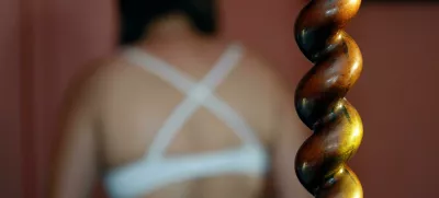 2KG2WTW Back of a woman wearing a bra. Victim waiting for help. Sexual violence concept.