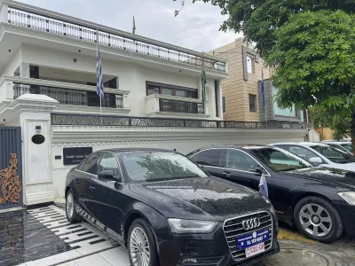 Luxury cars cars bearing fake diplomatic number plates are parked outside a rented residential building in which a bogus embassy was running in Ghaziabad, outskirts of New Delhi, India, Monday, July 21, 2025. (Uttar Pradesh Police Special Task Force via AP)