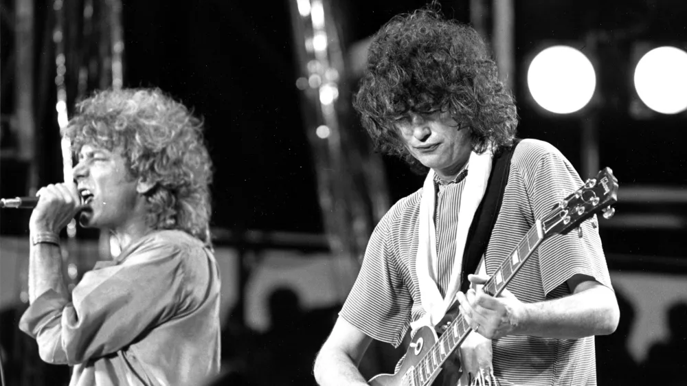 ﻿FILE - In this July 13, 1985 file photo, singer Robert Plant, left, and guitarist Jimmy Page of the British rock band Led Zeppelin perform at the Live Aid concert at Philadelphia's J.F.K. Stadium. Generations of aspiring guitarists have tried to copy the riff from Led Zeppelin's â€śStairway to Heaven.â€ť Starting Tuesday, June 14, 2016, a Los Angeles court will try to decide whether the members of Led Zeppelin themselves ripped off that riff. Page and Plant are named as defendants in the lawsuit brought by the trustee of late guitarist Randy Wolfe from the band Spirit. (AP Photo/Rusty Kennedy, File)
