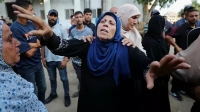 A woman mourns at a funeral of Palestinians killed by Israeli fire while trying to receive aid and others who were killed in an overnight Israeli strike, according to medics, at Al-Shifa Hospital in Gaza City, July 26, 2025. REUTERS/Mahmoud Issa