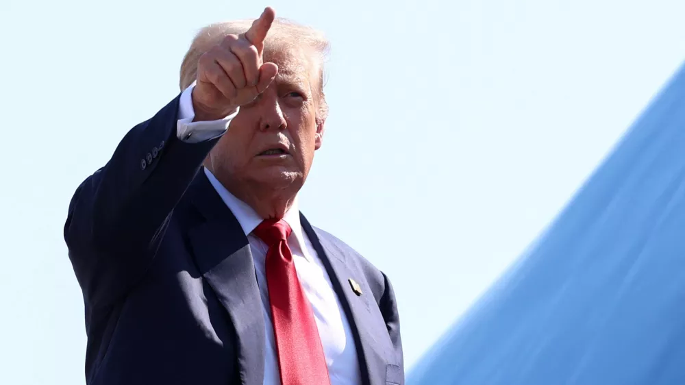 U.S. President Donald Trump gestures while boarding Air Force One, as he departs for Scotland, at Joint Base Andrews, Maryland, U.S., July 25, 2025. REUTERS/Evelyn Hockstein  REFILE - QUALITY REPEAT