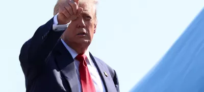 U.S. President Donald Trump gestures while boarding Air Force One, as he departs for Scotland, at Joint Base Andrews, Maryland, U.S., July 25, 2025. REUTERS/Evelyn Hockstein  REFILE - QUALITY REPEAT
