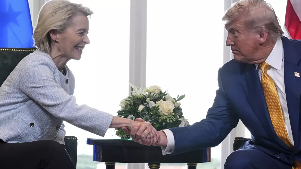 President Donald Trump and European Commission President Ursula von der Leyen shake hands after reaching a trade deal at the Trump Turnberry golf course in Turnberry, Scotland Sunday, July 27, 2025. (AP Photo/Jacquelyn Martin)