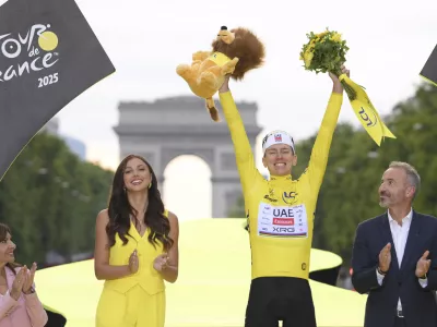 Slovenia's Tadej Pogacar, the Tour de France winner, celebrates during the presentation ceremony for the Tour de France on the Champs-Elysees in Paris, France, Sunday, July 27, 2025. (Bernard Papon, Pool Photo via AP)