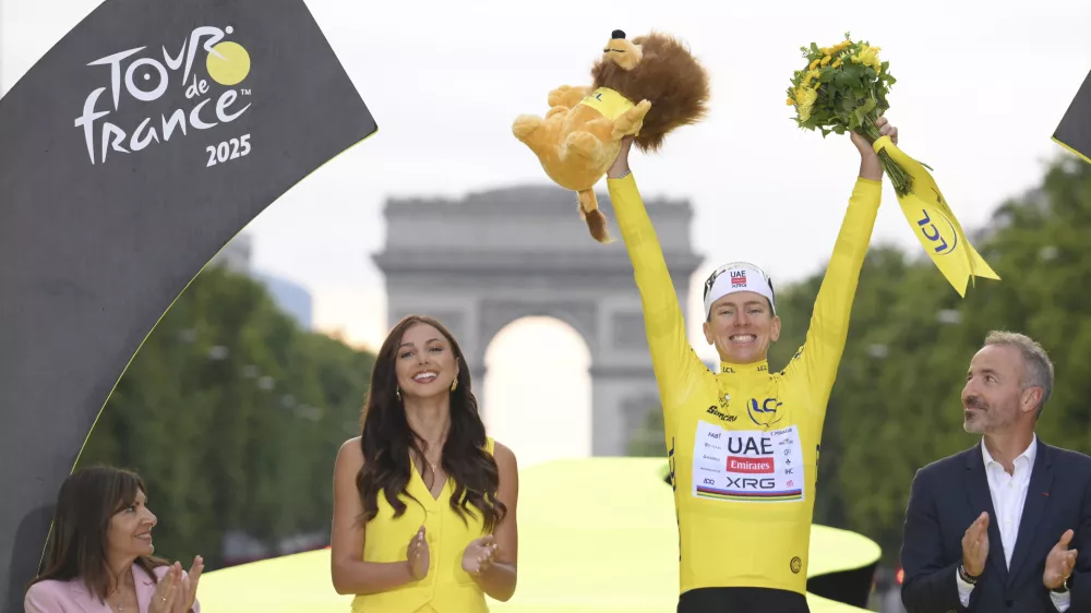 Slovenia's Tadej Pogacar, the Tour de France winner, celebrates during the presentation ceremony for the Tour de France on the Champs-Elysees in Paris, France, Sunday, July 27, 2025. (Bernard Papon, Pool Photo via AP)