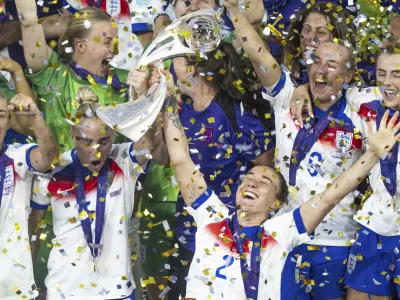 England's Lucy Bronze celebrates with the trophy after winning the Women's Euro 2025 final soccer match between England and Spain at St. Jakob-Park in Basel, Switzerland, Sunday, July 27, 2025. (Til Buergy/Keystone via AP)