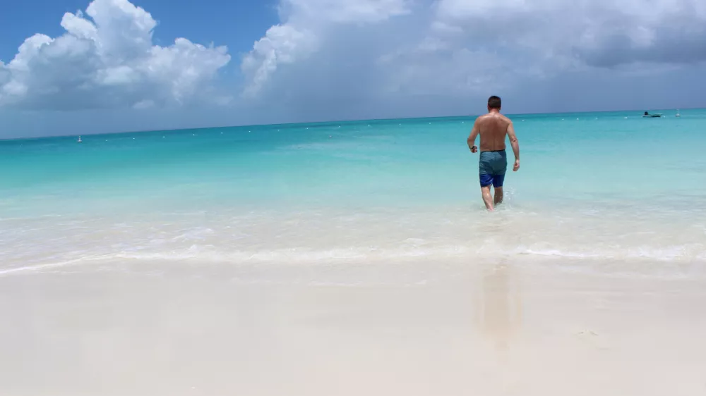 Man walking into ocean