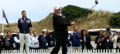 Eric Trump applauds as his father, U.S. President Donald Trump, tees off, on the day of the grand opening of Trump International Golf Links Aberdeen in Balmedie, Aberdeen, Scotland, Britain, July 29, 2025. REUTERS/Evelyn Hockstein