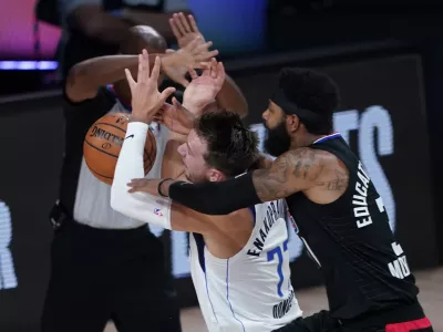 ﻿Dallas Mavericks' Luka Doncic (77) is fouled by Los Angeles Clippers' Marcus Morris Sr. during the first half of an NBA first round playoff game Sunday, Aug. 30, 2020, in Lake Buena Vista, Fla. (AP Photo/Ashley Landis)