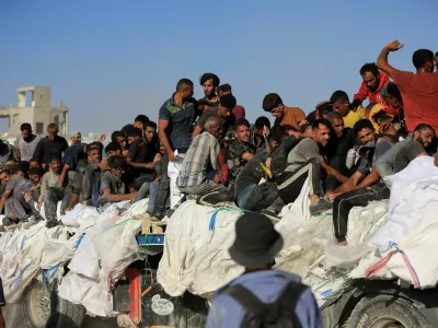 Palestinians sit on aid supplies that entered Gaza through Israel, in Beit Lahia in the northern Gaza Strip, July 30, 2025. REUTERS/Dawoud Abu Alkas   TPX IMAGES OF THE DAY