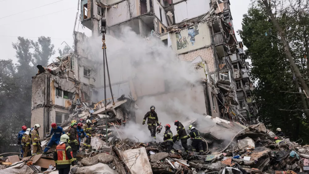 31 July 2025, Ukraine, Kiev: Rescue workers search for survivors under the rubble of a destroyed residential building after a Russian missile attack that struck Kiev. Photo: Svet Jacqueline/ZUMA Press Wire/dpa