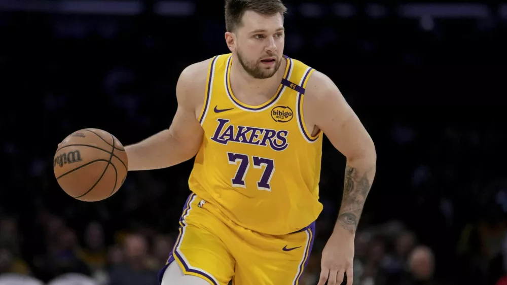 Los Angeles Lakers guard Luka Doncic (77) dribbles up the court during the first half of Game 2 of an NBA first-round playoff series against the Minnesota Timberwolves in Los Angeles, Tuesday, April 22, 2025. (AP Photo/Eric Thayer)
