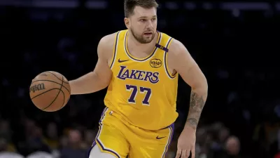 Los Angeles Lakers guard Luka Doncic (77) dribbles up the court during the first half of Game 2 of an NBA first-round playoff series against the Minnesota Timberwolves in Los Angeles, Tuesday, April 22, 2025. (AP Photo/Eric Thayer)