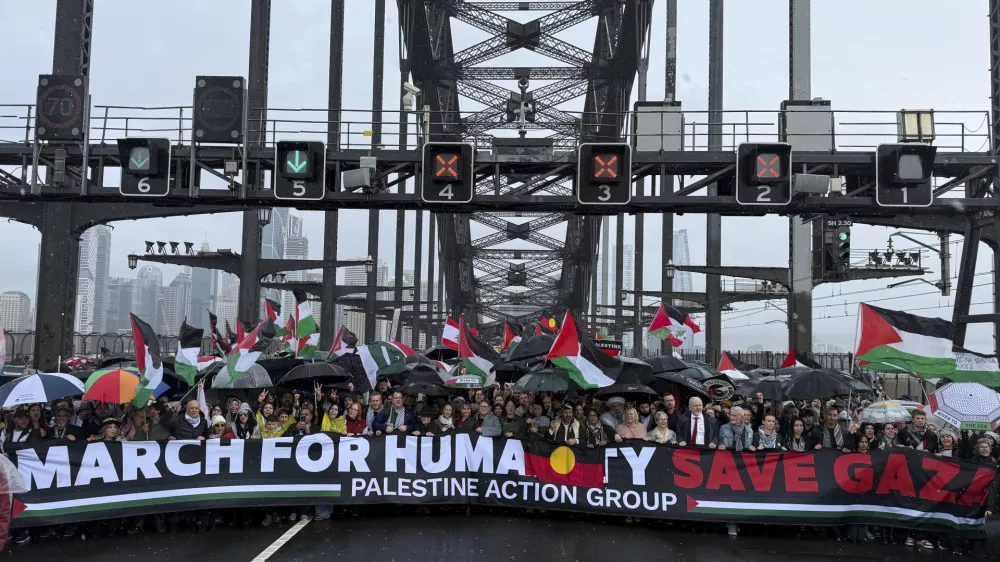 Thousands of protesters walk across the Sydney Harbour Bridge during the Palestine Action Group's March for Humanity in Sydney, Sunday, Aug. 3, 2025. (Dean Lewins/AAP Image via AP)