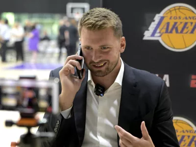 Aug 2, 2025; El Segundo, CA, USA; Los Angeles Lakers Luka Doncic (77) is interviewed by ESPN LA radio following a press conference announcing the signing of a 3-year, 5 million contract extension at UCLA Health Training Center. Mandatory Credit: Jayne Kamin-Oncea-Imagn Images