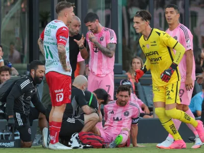 Aug 2, 2025; Fort Lauderdale, FL, USA; Inter Miami CF forward Lionel Messi (10) is looked at by trainees after a possible injury against Necaxa during the first half of a Leagues Cup group stage match at Chase Stadium. Mandatory Credit: Sam Navarro-Imagn Images