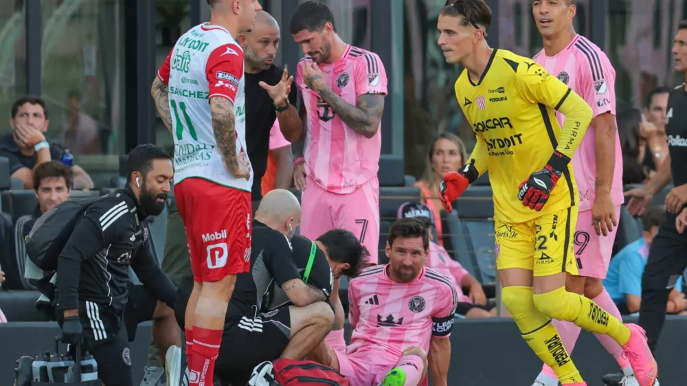 Aug 2, 2025; Fort Lauderdale, FL, USA; Inter Miami CF forward Lionel Messi (10) is looked at by trainees after a possible injury against Necaxa during the first half of a Leagues Cup group stage match at Chase Stadium. Mandatory Credit: Sam Navarro-Imagn Images