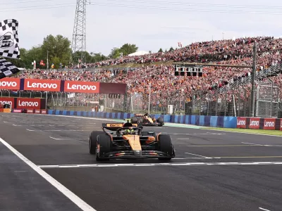 McLaren driver Lando Norris of Britain crosses the finish line to win the Hungarian Formula One Grand Prix race at the Hungaroring racetrack in Mogyorod, Hungary, Sunday, Aug. 3, 2025. (Anna Szilagyi/Pool Photo via AP)