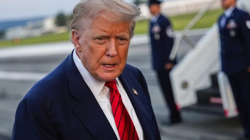 President Donald Trump speaks with reporters before boarding Air Force One at Lehigh Valley International Airport, Sunday, Aug. 3, 2025, in Allentown, Pa. (AP Photo/Julia Demaree Nikhinson)