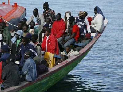 Would-be immigrants arrive at the port of Santa Cruz de Tenerife in Spain's Canary island of Tenerife June 10, 2007. Some 135 would-be immigrants were intercepted aboard a fishing boat on their way to reach European soil from Africa, according to authorities.REUTERS/Juan Medina (SPAIN)