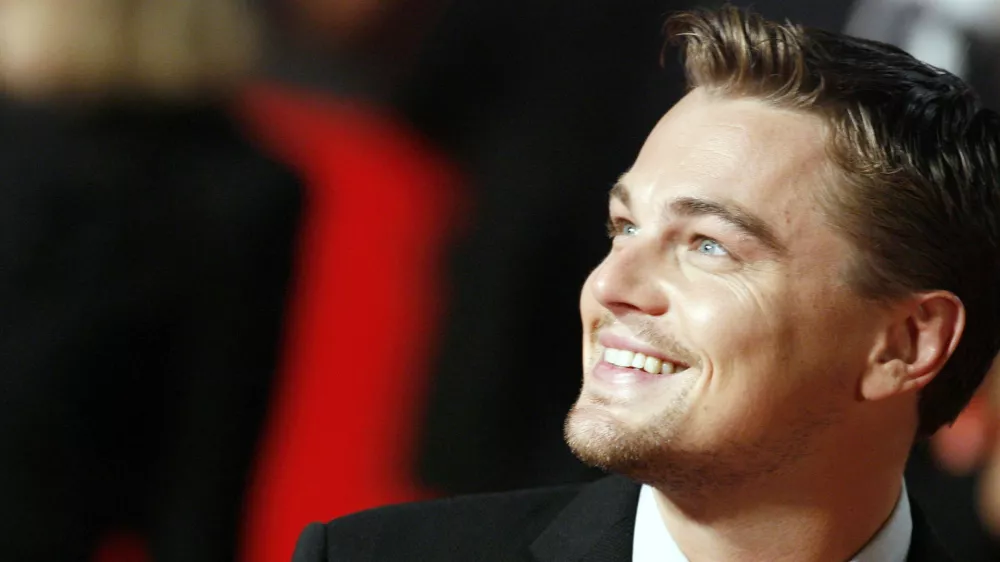 ** ALTERNATIVE CROP ** Actor Leonardo Di Caprio smiles as he arrives at Rome's Auditorium, Sunday, Oct. 15, 2006, to present the movie "The Departed," at the first ever edition of the Rome Film Festival. (AP Photo/Andrew Medichini)