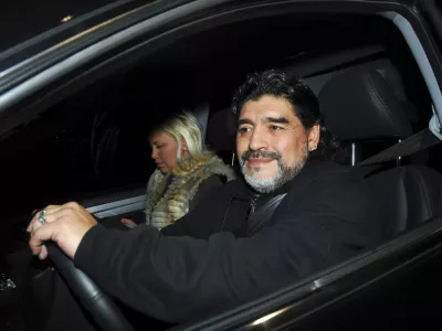 Former Argentine soccer star and coach Diego Maradona drives his car along with his girlfriend Veronica Ojeda in Buenos Aires July 8, 2011. Maradona and his girlfriend escaped serious injury on Monday when his car was involved in a collision with a bus near his Buenos Aires home, local media and officials said. Picture taken July 8, 2011. REUTERS/Enrique Garcia Medina (ARGENTINA - Tags: DISASTER PROFILE SPORT SOCCER)
