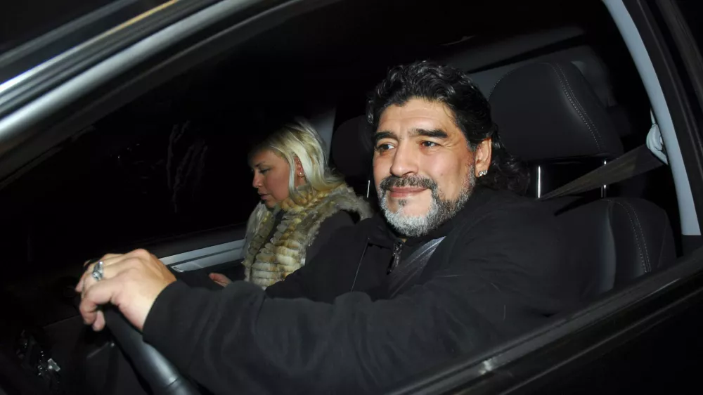Former Argentine soccer star and coach Diego Maradona drives his car along with his girlfriend Veronica Ojeda in Buenos Aires July 8, 2011. Maradona and his girlfriend escaped serious injury on Monday when his car was involved in a collision with a bus near his Buenos Aires home, local media and officials said. Picture taken July 8, 2011. REUTERS/Enrique Garcia Medina (ARGENTINA - Tags: DISASTER PROFILE SPORT SOCCER)