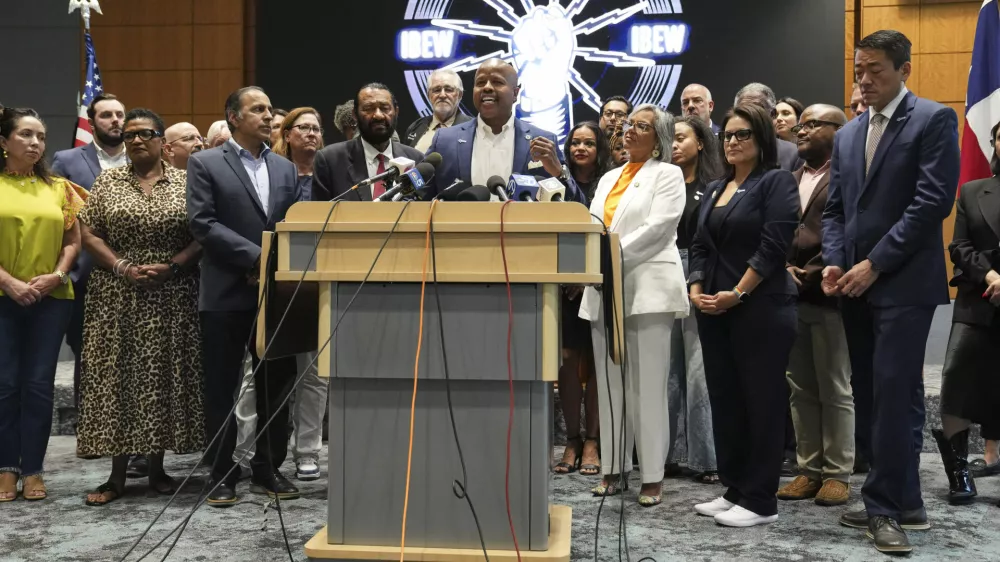Democratic Texas Rep. Ron Reynolds, center, surrounded by other Texas House Democrats and Democratic members of Congress, speaks during a press conference at the Democratic Party in Warrenville, Ill., Monday, Aug. 4, 2025. (AP Photo/Nam Y. Huh)