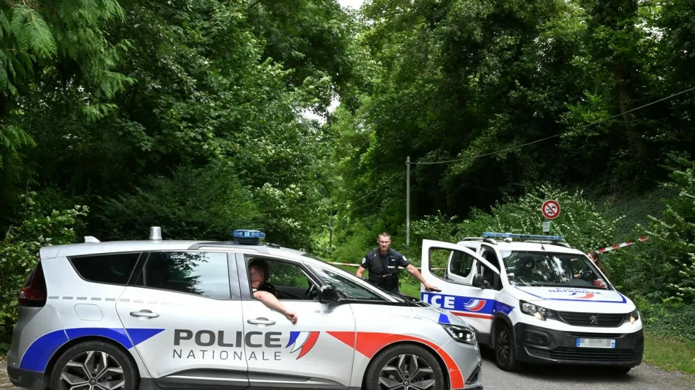 Police France, francija, policija, french police, francoska policijaPolice cars are parked in front of a cordoned-off area, near a sports field where a 32-year-old man was found dead with his throat slit and gutted, in Pont-de-Metz on August 4, 2025. The victim had stab wounds to the neck and back and has been found by a walker in a cross position, police told AFP.,Image: 1027676326, License: Rights-managed, Restrictions:, Model Release: no