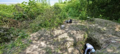 Rebun Kayo, a Hiroshima University researcher, searches for remains of victims of the 1945 Hiroshima bombing in Ninoshima in Hiroshima, western Japan, Tuesday, July 8, 2025. (AP Photo/Eugene Hoshiko)