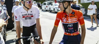 Slovenian rider Tadej Pogacar, left, and his girld friend Urska Zigart from Slovenia of AG Insurance - Soudal Team, right, in the finish area during the second stage, a 123,2 km race between Conthey and La Tzoumaz at the 4rd Tour de Romandie Feminin UCI Women's World Tour cycling race in La Tzoumaz, Switzerland, Saturday, Aug. 16, 2025. (Cyril Zingaro/Keystone via AP)