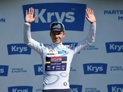 FILE PHOTO: Cycling - Tour de France - Stage 8 - Saint-Meen-le-Grand to Laval - Laval, France - July 12, 2025 Soudal Quick-Step's Remco Evenepoel celebrates on the podium wearing the white jersey after stage 8 REUTERS/Benoit Tessier/File Photo