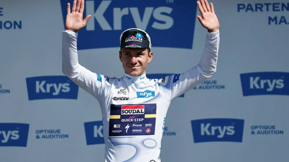 FILE PHOTO: Cycling - Tour de France - Stage 8 - Saint-Meen-le-Grand to Laval - Laval, France - July 12, 2025 Soudal Quick-Step's Remco Evenepoel celebrates on the podium wearing the white jersey after stage 8 REUTERS/Benoit Tessier/File Photo