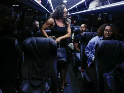 Democratic lawmakers from Texas sit inside a bus following a press conference with Illinois Governor J.B. Pritzker, after leaving their state to deny Republicans the quorum needed to redraw the state's 38 congressional districts, in Carol Stream, Illinois, U.S., August 3, 2025. REUTERS/Kamil Krzaczynski