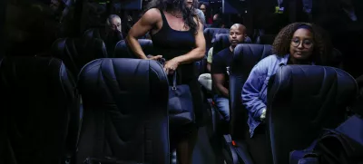 Democratic lawmakers from Texas sit inside a bus following a press conference with Illinois Governor J.B. Pritzker, after leaving their state to deny Republicans the quorum needed to redraw the state's 38 congressional districts, in Carol Stream, Illinois, U.S., August 3, 2025. REUTERS/Kamil Krzaczynski