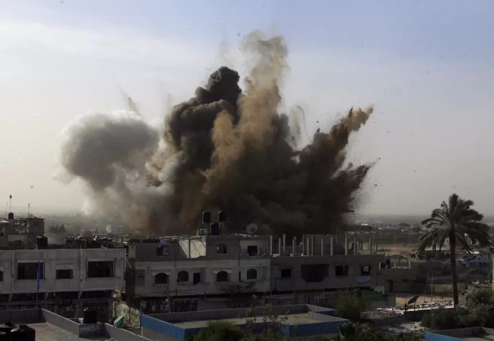 An explosion is seen where the Israeli military is bombing an area around alleged smuggling tunnels in Rafah southern Gaza Strip, Wednesday, Jan. 14, 2009.  Israel showed no signs of slowing its bruising 19-day offensive against Gaza's Hamas rulers, striking some 60 targets on Wednesday. Israel launched the onslaught on Dec. 27, seeking to punish the Hamas militant group for years of rocket attacks on southern Israel. The offensive has killed more than 940 Palestinians, half of them civilians, according to Palestinian hospital official.(AP Photo/Eyad Baba)