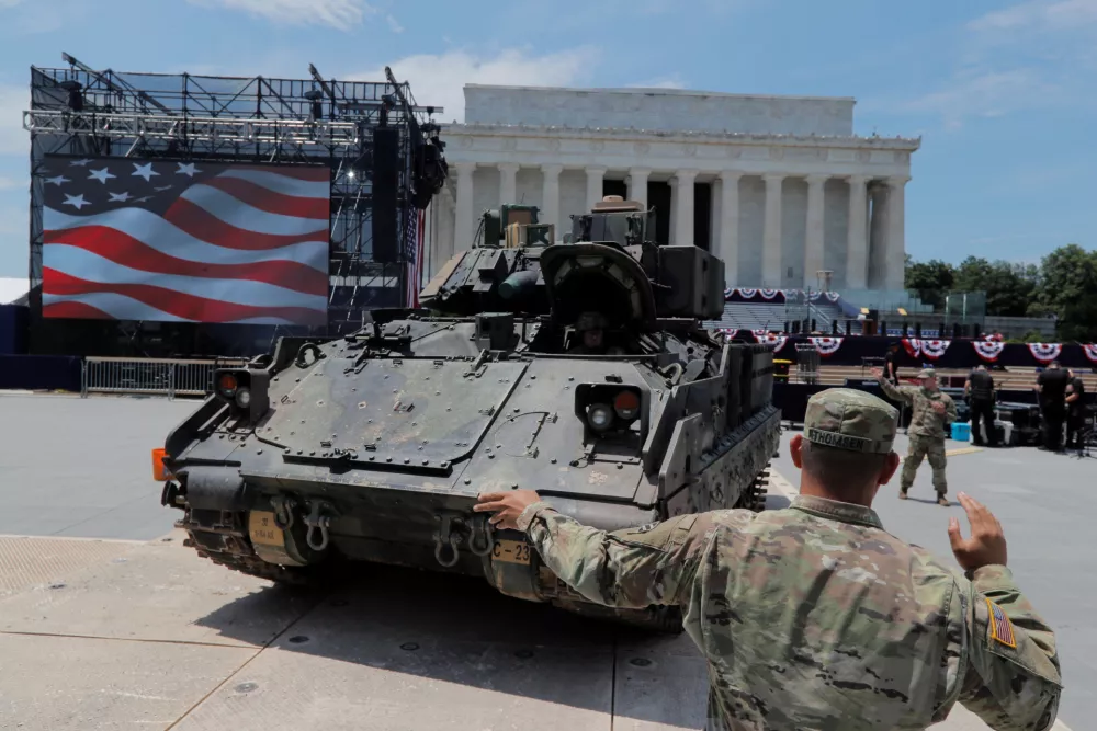 ﻿A member of the U.S. Army's 3rd Infantry Division, 1st Battalion, 64th Armored Regiment based at Fort Stewart, Georgia assists as a Bradley Fighting Vehicle is moved into place at the Lincoln Memorial ahead of a July Fourth celebration highlighting U.S. military might in Washington, U.S., July 3, 2019. REUTERS/Jim Bourg   TPX IMAGES OF THE DAY