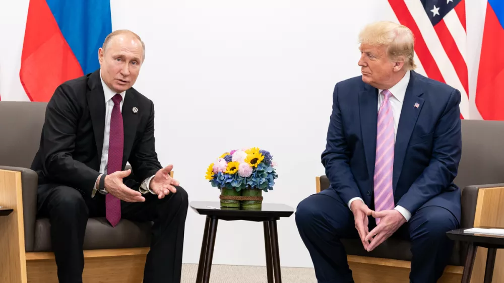 FILED - 14 June 2019, Japan, Osaka: US President Donald Trump (R) shakes hands with Russian President Vladimir Putin during their meeting on the sidelines of the 2019 G20 summit. Photo: -/White House/dpa - ATTENTION: editorial use only and only if the credit mentioned above is referenced in full