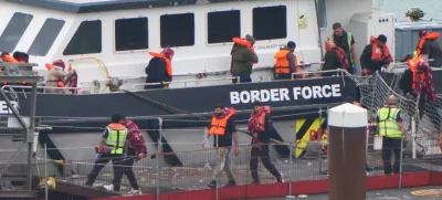 07 August 2025, United Kingdom, Dover: A group of people thought to be migrants are brought in to the Border Force compound in Dover, Kent, from a Border Force vessel following a small boat incident in the Channel. Photo: Gareth Fuller/PA Wire/dpa