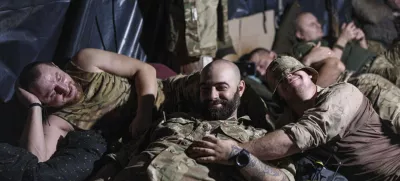 Ukrainian servicemen of the 148th artillery brigade rest in a dugout at the frontline in Zaporizhzhia region, Ukraine, on Thursday, Aug. 7, 2025. (AP Photo/Evgeniy Maloletka)