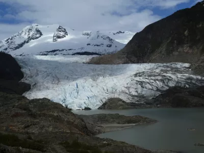 FILE - A canoe, bottom right, glides on Mendenhall Lake, in front of the Mendenhall Glacier, on Sunday, May 18, 2025, in Juneau, Alaska. (AP Photo/Becky Bohrer, File)