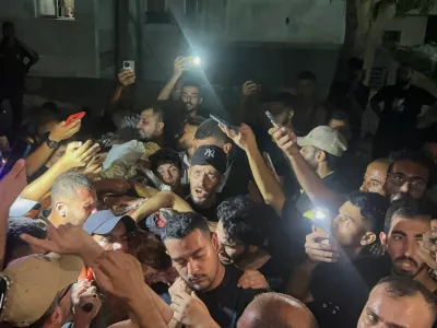 Palestinians hold the body of Al Jazeera journalist Anas Al-Sharif, who Israel's military and Al Jazeera say was killed by an Israeli strike, in Gaza City, August 11, 2025. REUTERS/Ebrahim Hajjaj