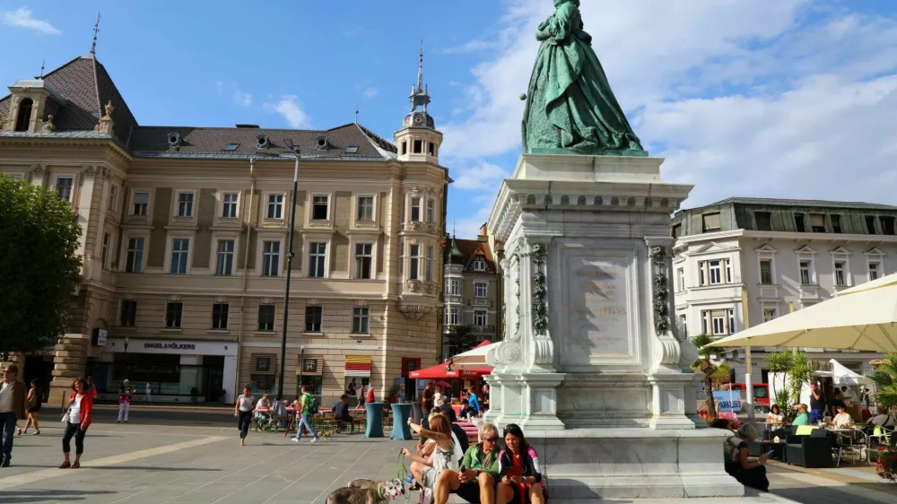 People visit empress Maria Theresia monument at Neuer Platz town square in Klagenfurt, Austria. Klagenfurt is the 6th largest city in Austria.