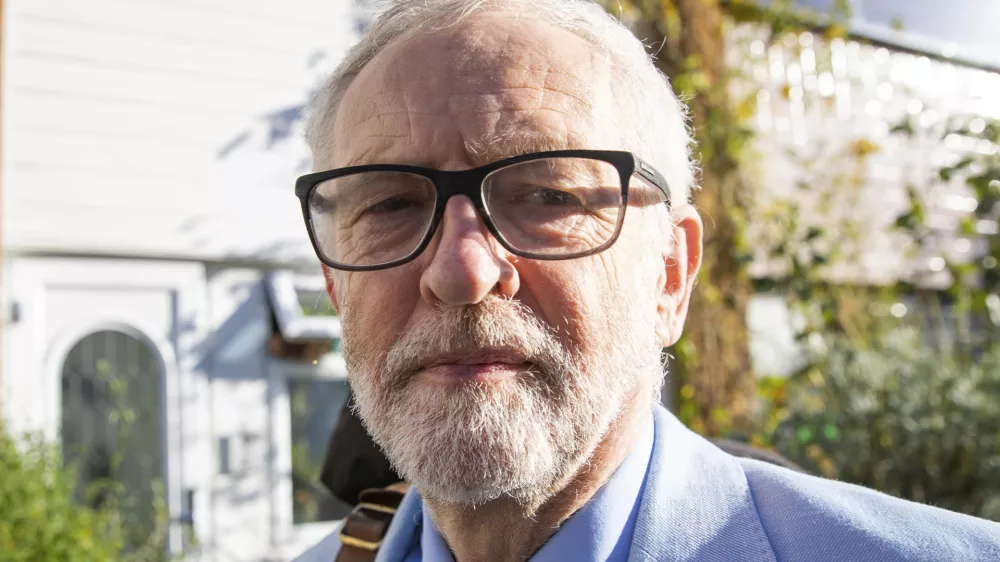 Britain's former opposition Labour Party leader Jeremy Corbyn leaves his home in London, Wednesday Nov. 18, 2020. Corbyn will be reinstated into the political party it is announced Wednesday after a three-week suspension as Labour&acirc;&euro;&trade;s National Executive Committee seeks to draw a line under years of tumultuous divisions over alleged anti-Jewish prejudice in the party. (Aaron Chown/PA via AP)