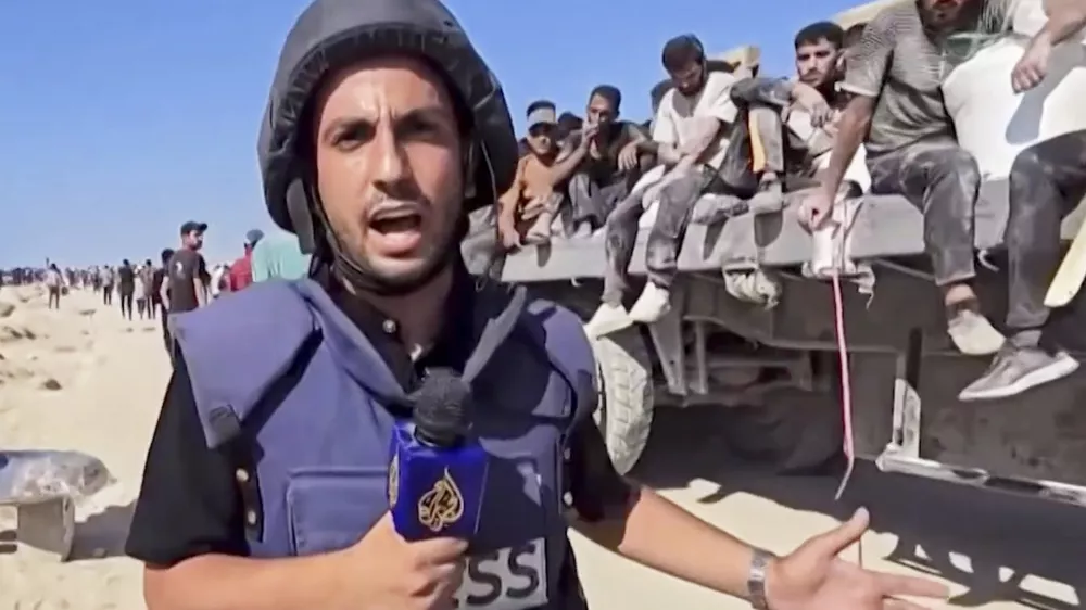 This undated recent image, taken from video broadcast by the Qatari-based television station Al Jazeera, shows the network's Arabic-language Gaza correspondent, Anas al-Sharif, reporting on camera in Gaza. Al-Sharif and four other Al Jazeera staff members were killed by an Israeli drone strike on their tent in Gaza City shortly before midnight on Sunday. (Al Jazeera via AP)